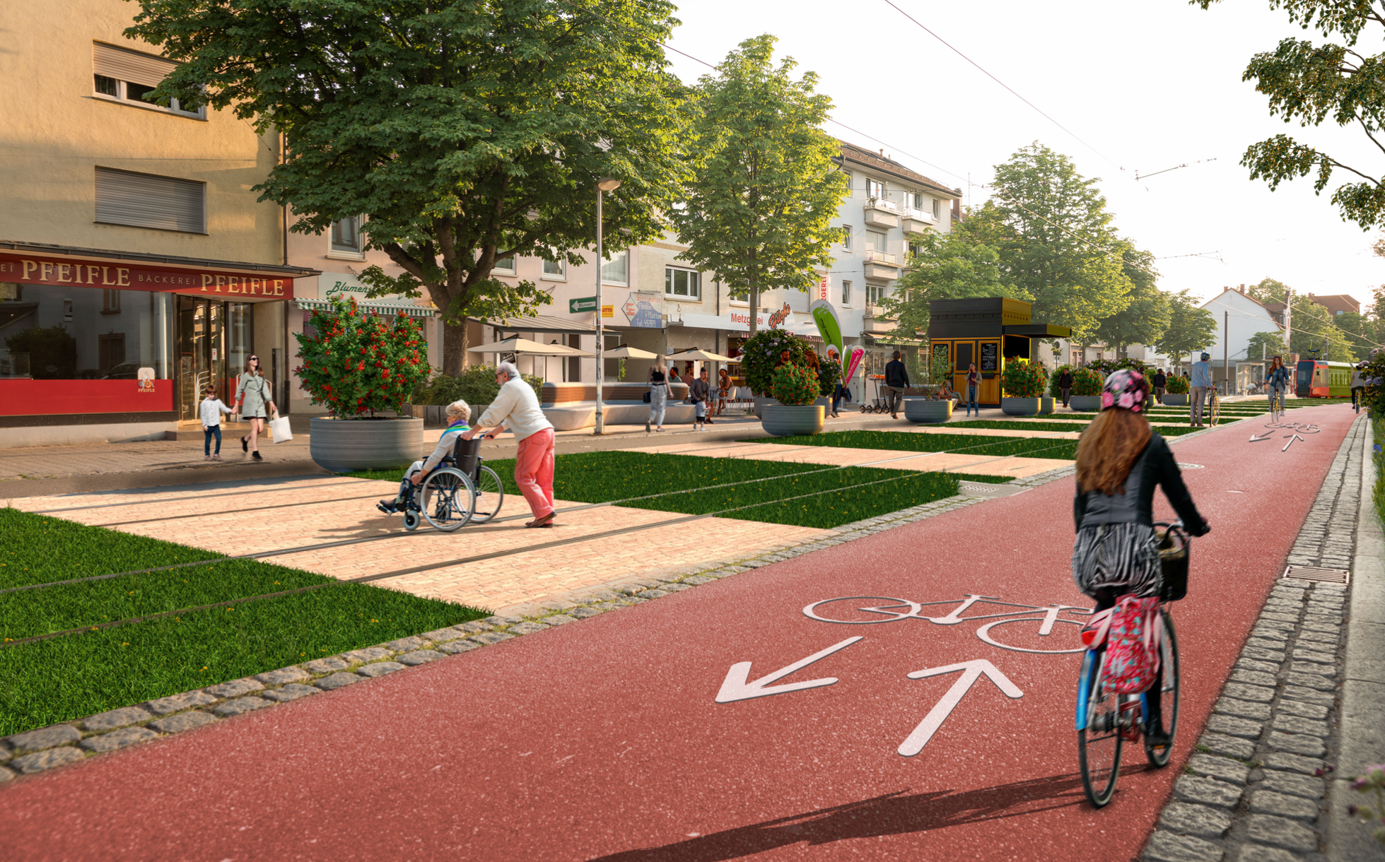 Illustration, wie die Carl-Kistner-Straße mal aussehen könnte. Die Straße ist verkehrsberuhigt: Es gibt keinen Durchgangsverkehr. Das Gleisbett der Straßenbahnen ist begrünt, was den Schall reduziert und Wasser leichter abfließen lässt. Auf der Straße fährt eine Schülerin mit dem Fahrrad. Eine Person im Rollstohl überquert zusammen mit ihrer Begleiterin die Straße. Eine Mutter kommt gerade aus der Bäckerei Pfeifle, in der einen Hand hält sie eine Einkaufstüte, in der anderen Hand hält sie ihr Kind.